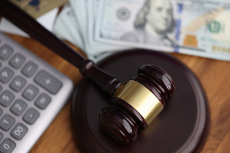 calculator, a gavel, and money
