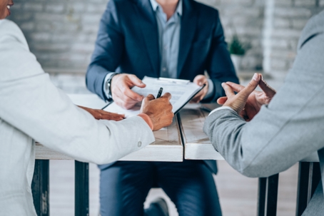 couple signing documents with a lawyer