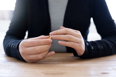 woman removing wedding ring