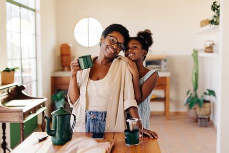 daughter hugging mother in the dining room