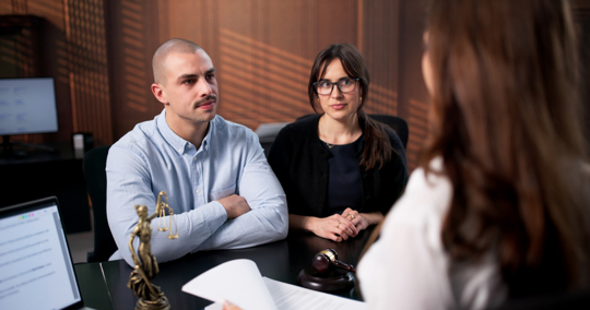 couple in a serious discussion with a lawyer